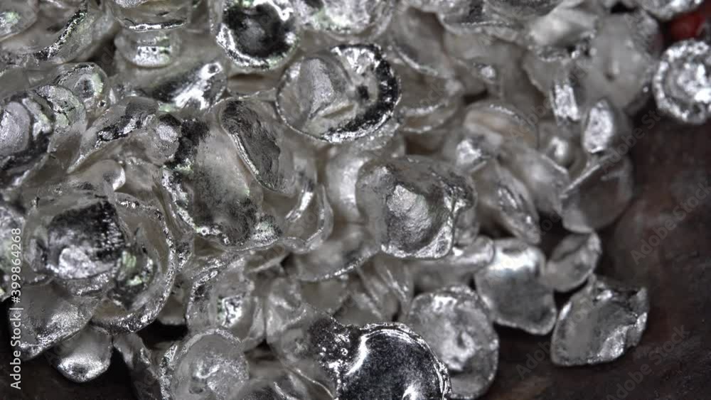 Silver particles drop into the jewelry plate for melting. Close up Silver particles drop into the jewelry plate for melting. Close up