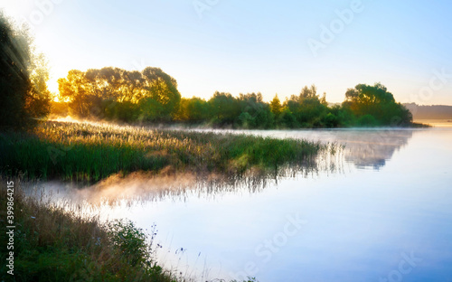 Fototapeta Naklejka Na Ścianę i Meble -  Beautiful sunrise over the river with fog.