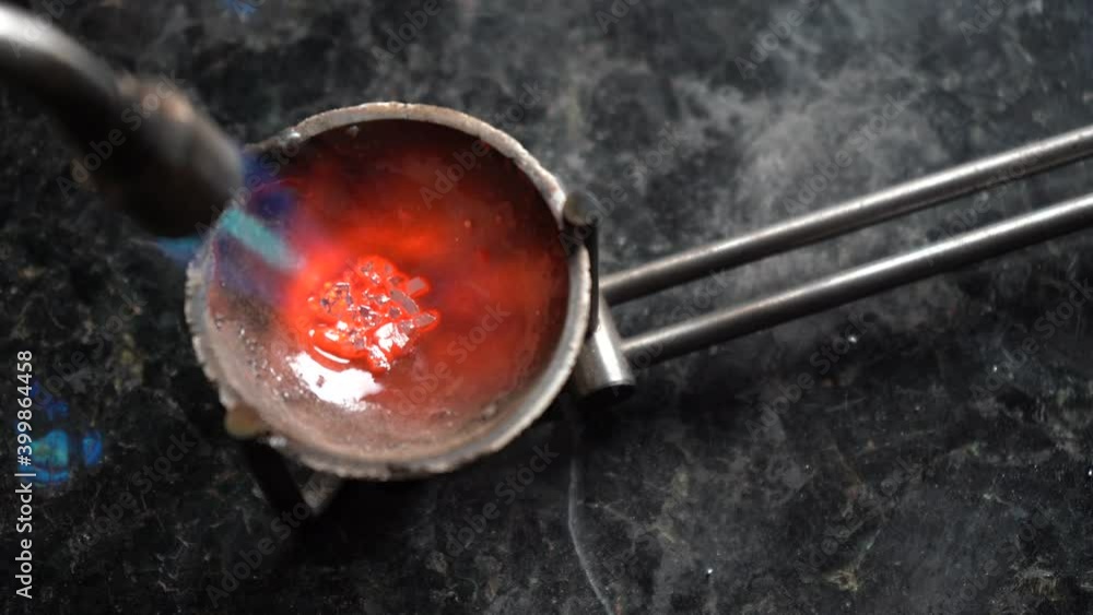 Jeweler melt silver with burner flame. Close up Jeweler melt silver with burner flame. Close up