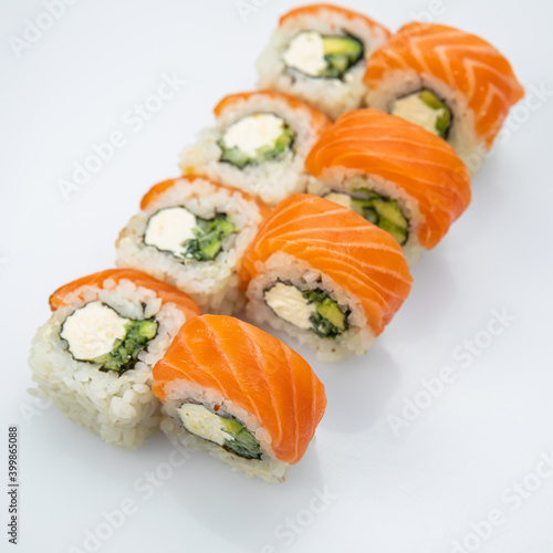 Japanese cuisine. Sushi roll with salmon on white background.