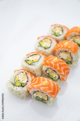 Japanese cuisine. Sushi roll with salmon on white background.