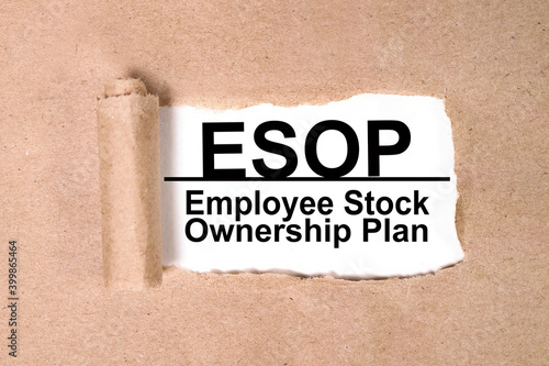 ESOP, text on white paper on torn paper background. photo