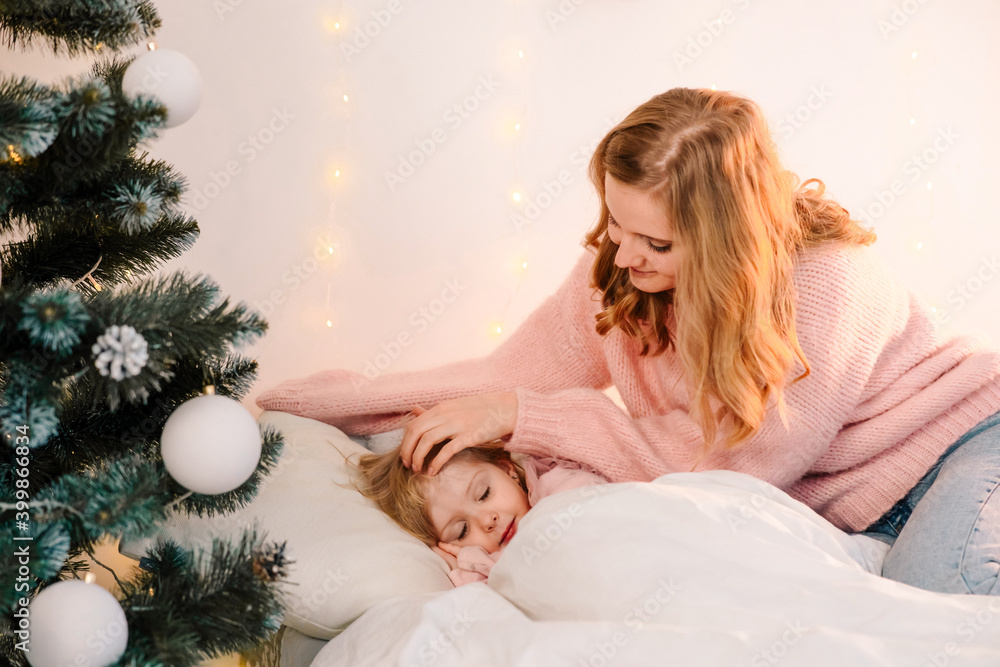 Mom caresses her little sleeping daughter Mom caresses her little sleeping daughter