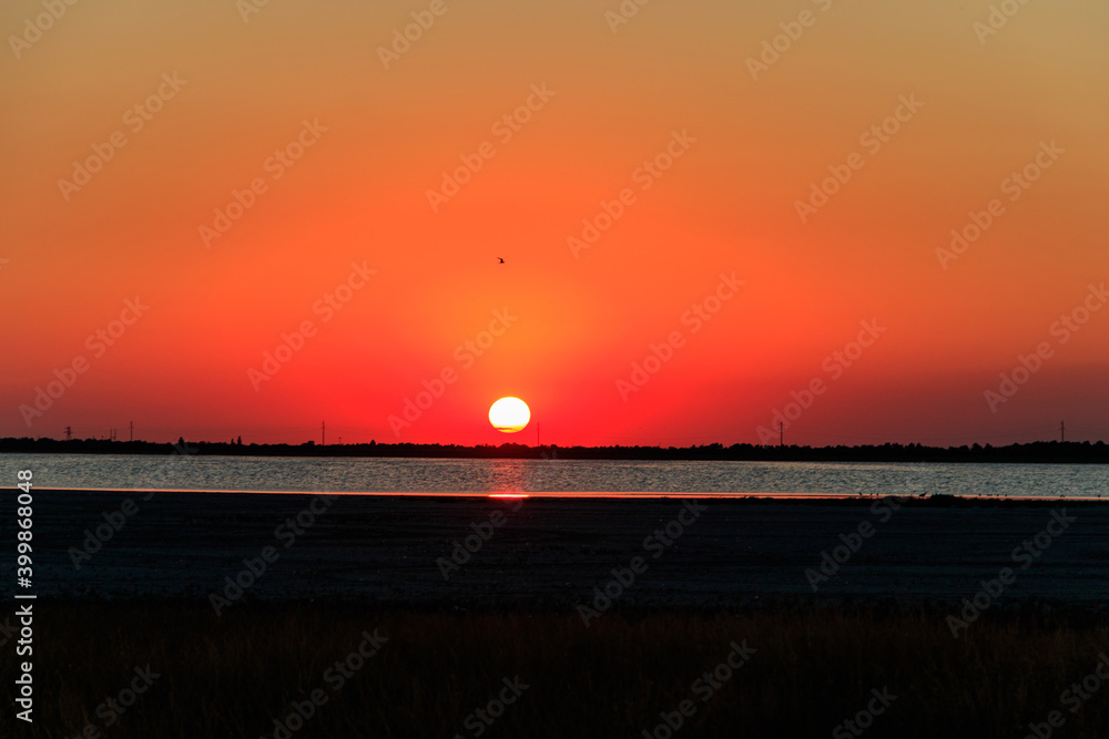 Beautiful orange sunset over a salt lake