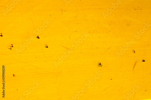 Yellow wooden old background on a sunny day
