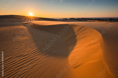 Obraz na płótnie Moving dunes in the Słowiński National Park during sunset. Amazing textures on sand bathed in golden light. w salonie