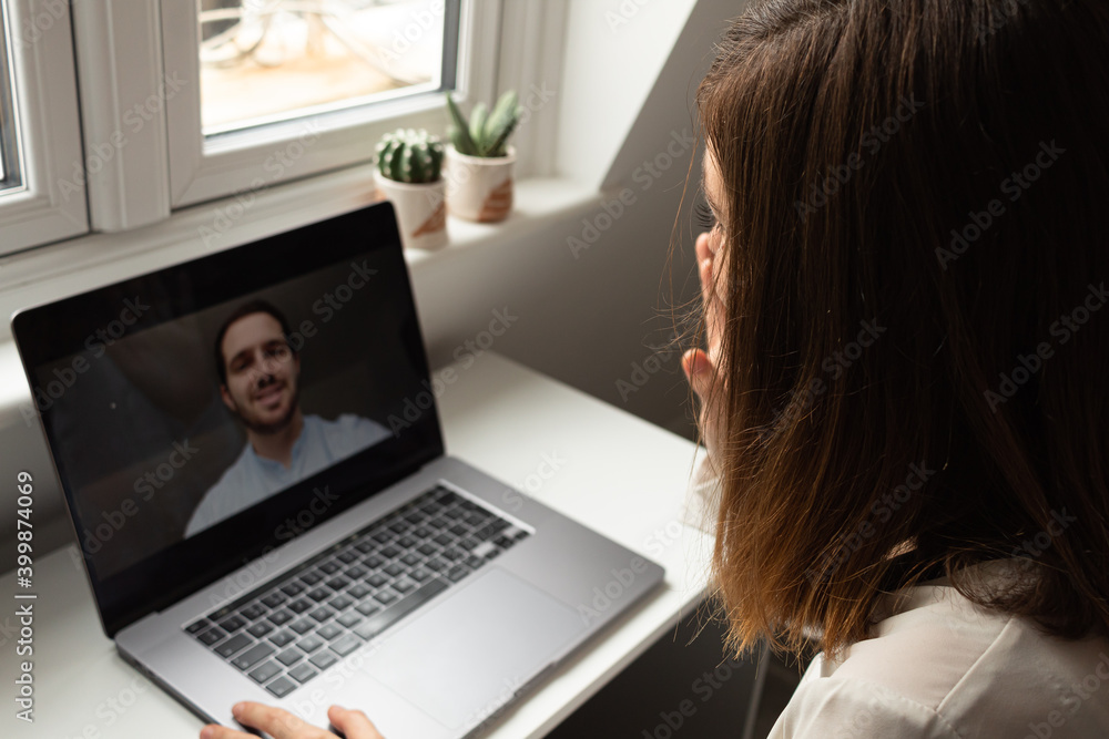 Attractive young female having a video call with a colleague while working from home during coronavirus outbreak Attractive young female having a video call with a colleague while working from home during coronavirus outbreak