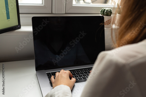 Attractive young female working from home during coronavirus outbreak. During 2020, most of the people have been forced to work from home due to the social distancing measures put in place. © Enrique