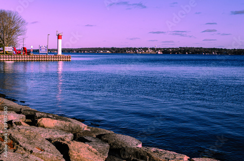 Rocky shoreline and entrance to a harbor in early evening photo