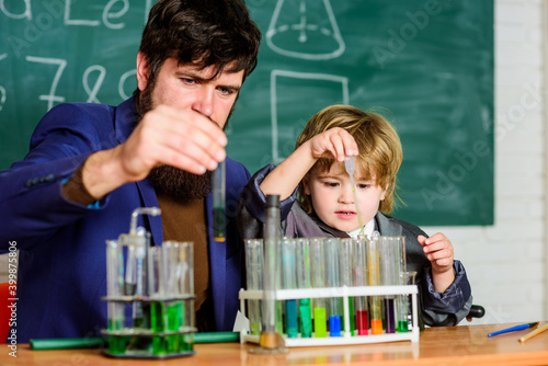 Educational school program. Schoolboy cute child experimenting with liquids. Teacher and child test tubes. School lesson. Perseverance pays off. Chemical experiment. Symptoms of ADHD at school