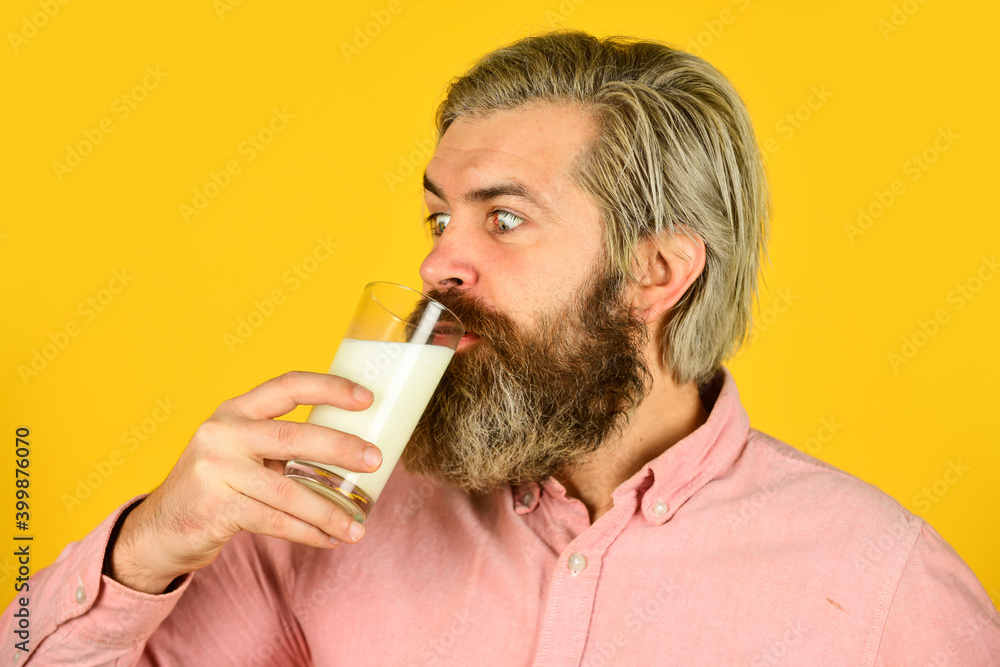 farmer present milk glass. bearded man drink useful milk. intestinal health concept. Useful and Vitamins. his favorite yoghurt. dairy production industry. vegan plant based milk farmer present milk glass. bearded man drink useful milk. intestinal health concept. Useful and Vitamins. his favorite yoghurt. dairy production industry. vegan plant based milk
