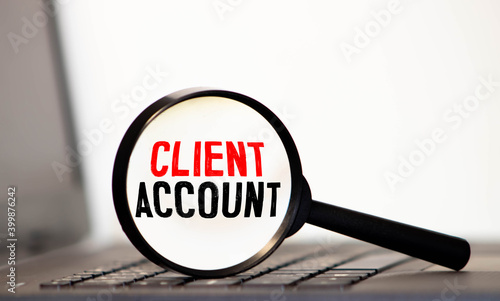 Magnifying glass with the words Client Account. Financial concept.