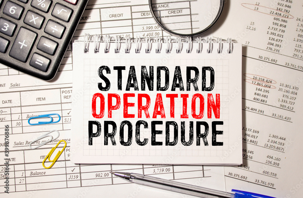 Standard Operating Procedure text on paper in open diary with spectacles. Standard Operating Procedure text on paper in open diary with spectacles.