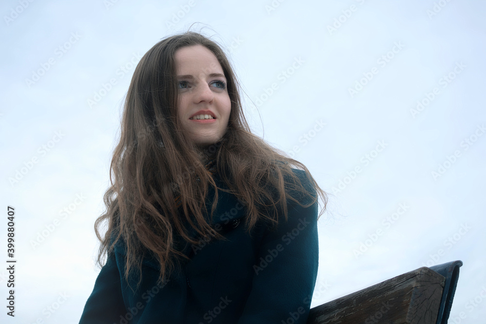 Portrait of a young smiling woman looking into the distance Portrait of a young smiling woman looking into the distance