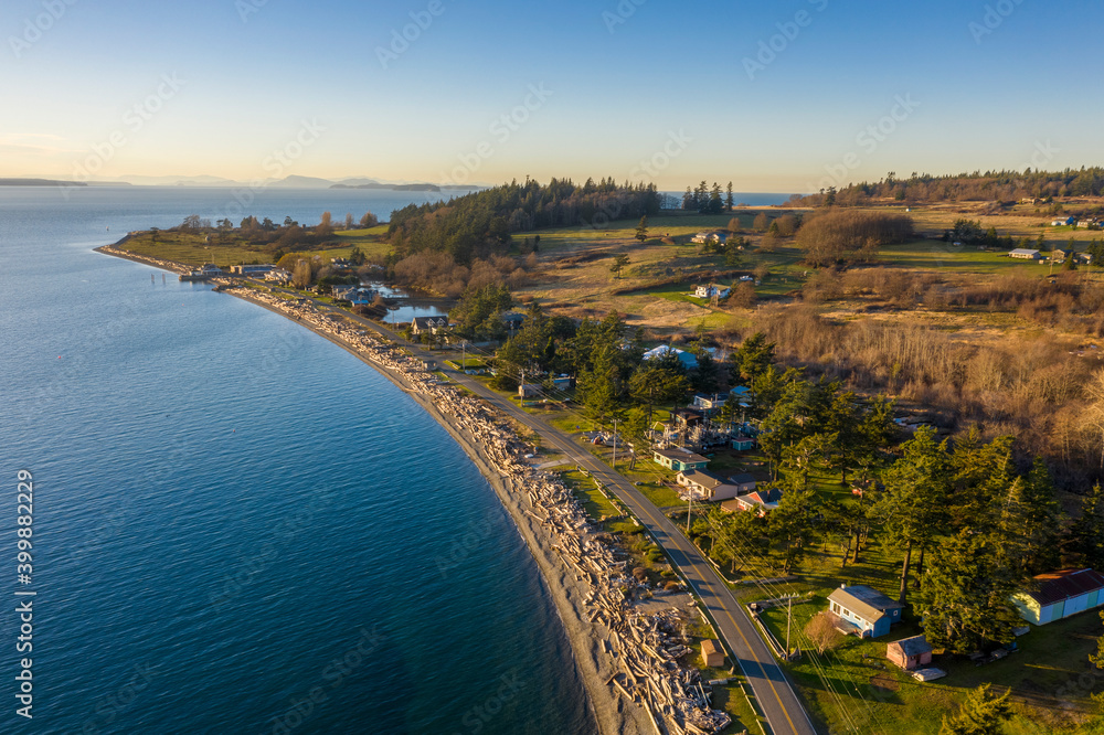 Aerial Waterfront View of Legoe Bay on Lummi Island. Driftwood covered beach and waterfront houses make this island ideal for a summertime visit. 