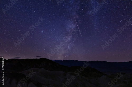 Zabriskie point death valley with the milky way and shooting star