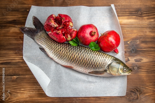 top view fresh fish with pomegranates on wooden desk ocean food sea seafood photo