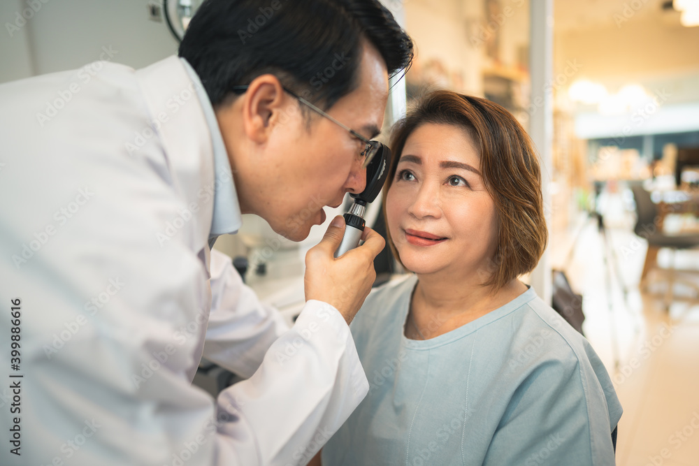 optometrist checking client eyes condition in optical store optometrist checking client eyes condition in optical store