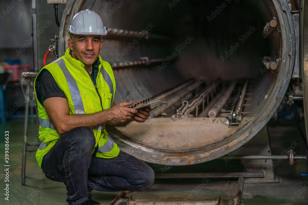 food factory engineer checking steam retort get ready to use food factory engineer checking steam retort get ready to use