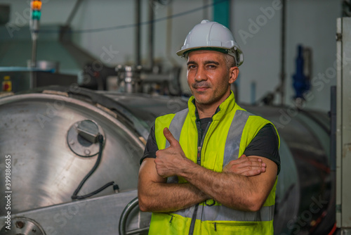 food factory engineer with steam retort in factory food processing room
