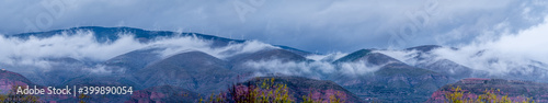 panoramic view of mountains and fogs touching the ground