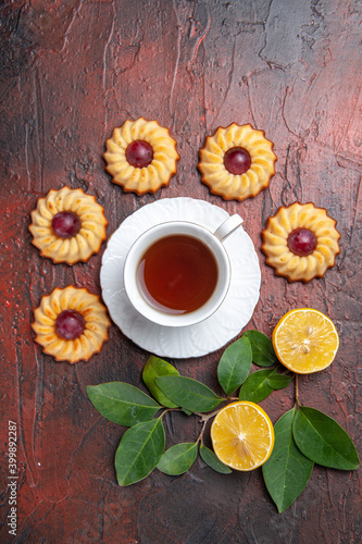 top view cup of tea with little cookies on a dark background biscuit sweet dessert