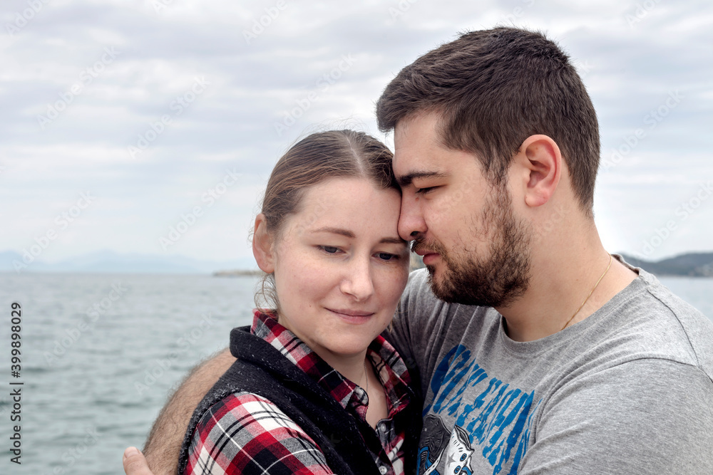 Loving couple hugging against the sea Loving couple hugging against the sea