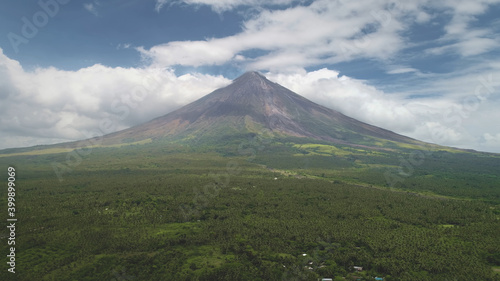 Closeup Philippines volcano haze eruption aerial. Green grass landmark of Mayon mountain with hiking path. Legazpi countryside mount. Nobody nature landscape at mist. Cinematic drone shot