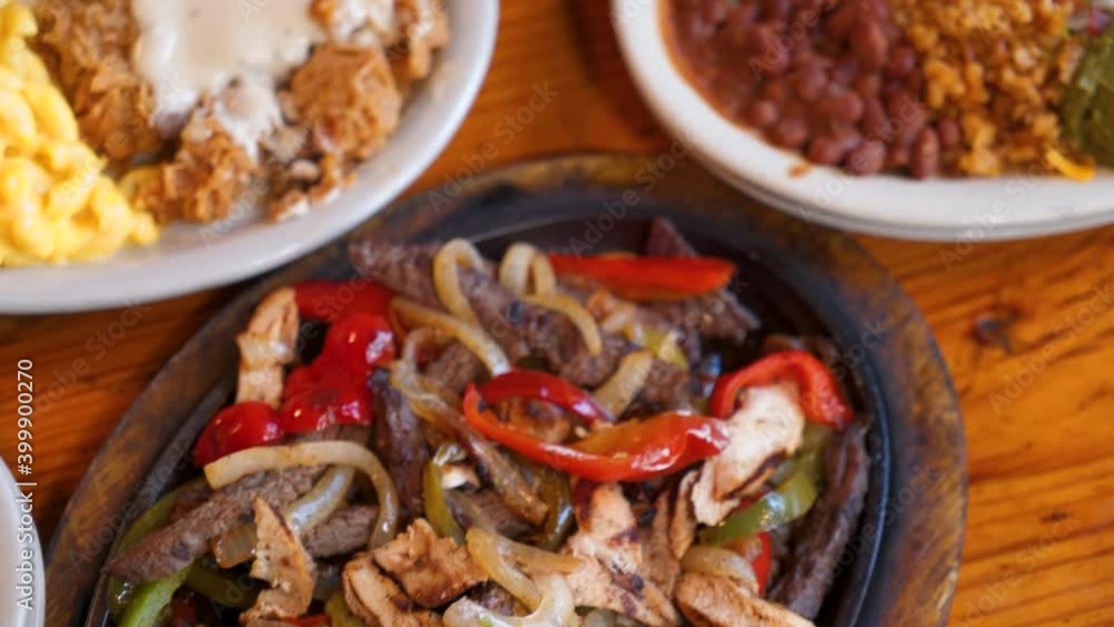 Tex-mex fajita platter with rice and beans, overhead slider slow motion 4K Tex-mex fajita platter with rice and beans, overhead slider slow motion 4K