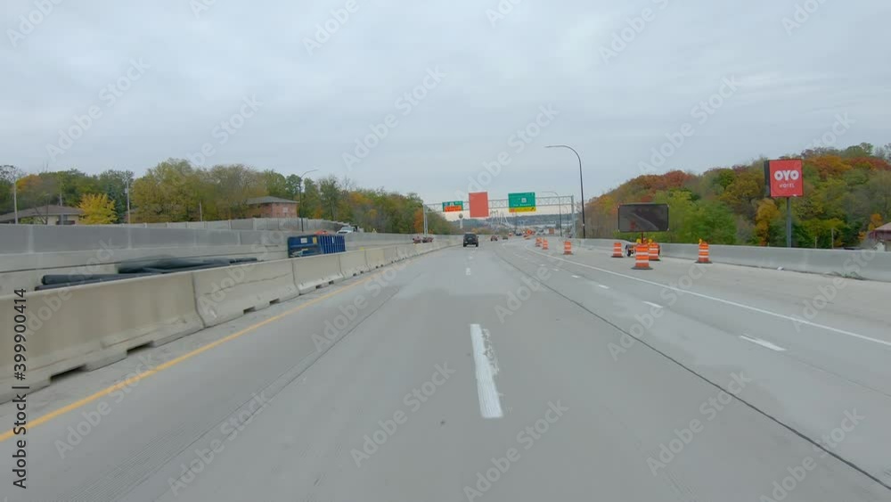 POV while driving thru a construction site on Interstate I74 near the Mississippi River; driving past a traffic digital speed display; in late Fall on a cloudy day in Moline Illinois POV while driving thru a construction site on Interstate I74 near the Mississippi River; driving past a traffic digital speed display; in late Fall on a cloudy day in Moline Illinois