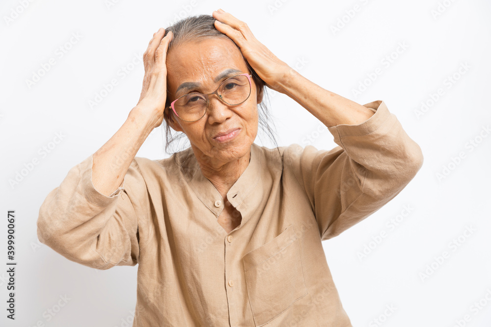 Old asian woman touch her head feel headache standing on white background. Old asian woman touch her head feel headache standing on white background.