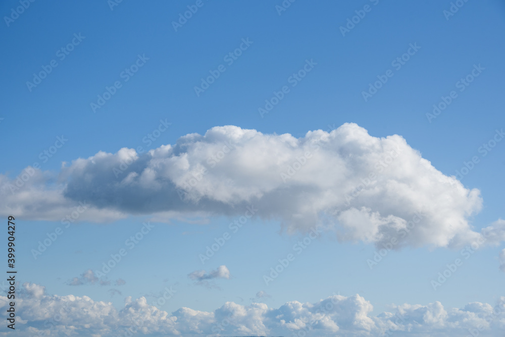 Tranquil blue sky with fluffy white clouds, as a nature background
Tranquil blue sky with fluffy white clouds, as a nature background