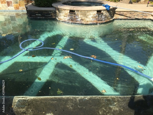 Pool with ash from house and local fire destroyed homes and vegetation in California
