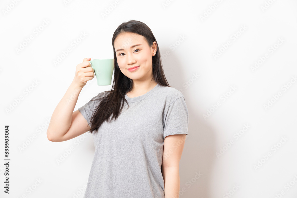 Gorgeous Asian woman drinking coffee and smiling standing over white background. Gorgeous Asian woman drinking coffee and smiling standing over white background.