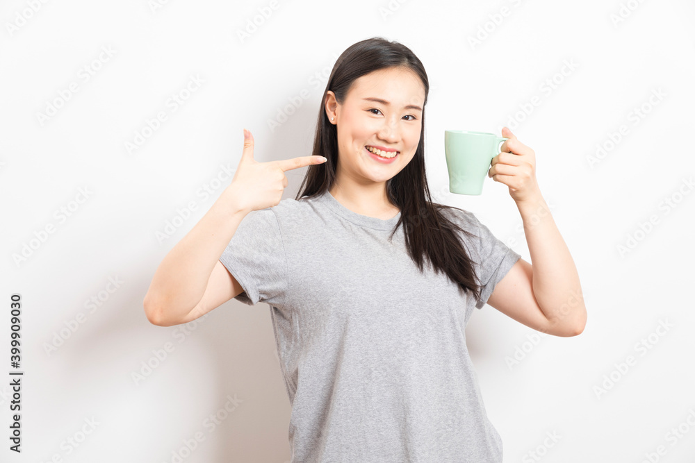 Gorgeous Asian woman drinking coffee and smiling standing over white background. Gorgeous Asian woman drinking coffee and smiling standing over white background.
