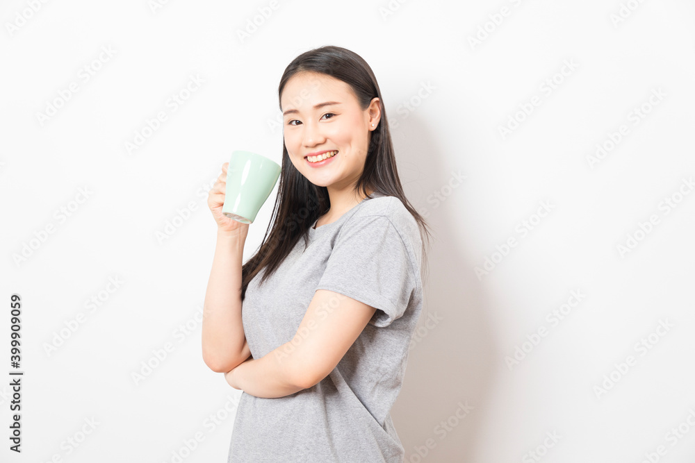 Gorgeous Asian woman drinking coffee and smiling standing over white background. Gorgeous Asian woman drinking coffee and smiling standing over white background.