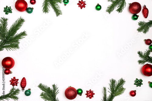 Christmas frame made of  decorations and fir branches on a white background.