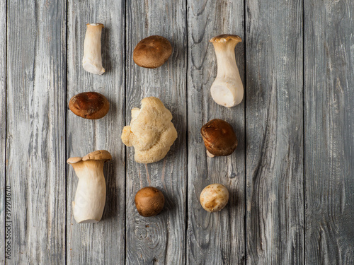 Set of mushrooms on wooden background.