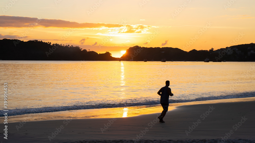 silhouette of a person on the beach at sunset