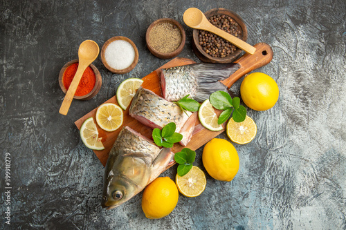 top view sliced fresh fish with lemon and seasonings on light background ocean raw seafood