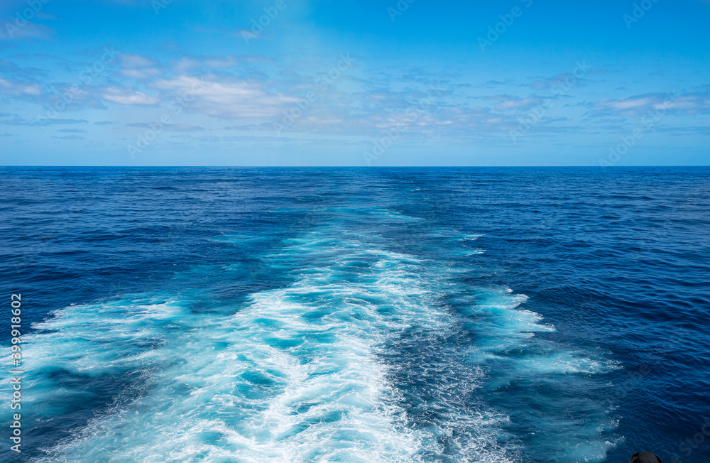 Beautiful view of cruise ship of ocean wave surface on deep blue colour taken from rear deck vantage point.