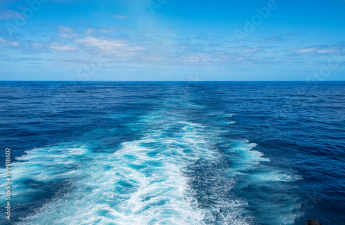 Beautiful view of cruise ship of ocean wave surface on deep blue colour taken from rear deck vantage point. © IKT224