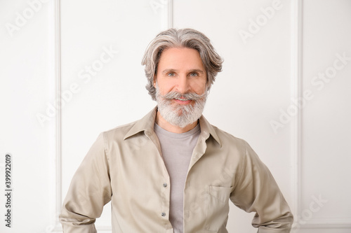 Cuadro en lienzo Mature man with grey hair on light background