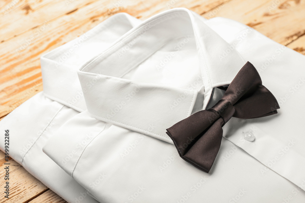 Stylish man shirts on wooden background, closeup Stylish man shirts on wooden background, closeup