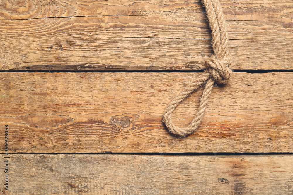Rope with knot on wooden background Rope with knot on wooden background