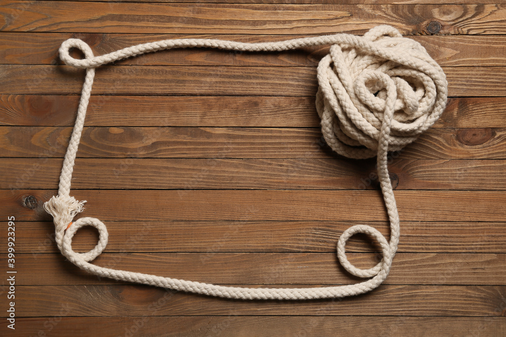 Frame made of rope on wooden background Frame made of rope on wooden background