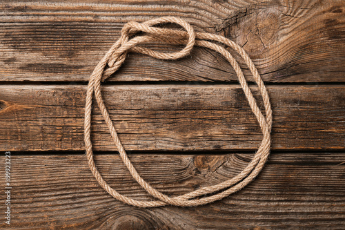 Frame made of rope on wooden background