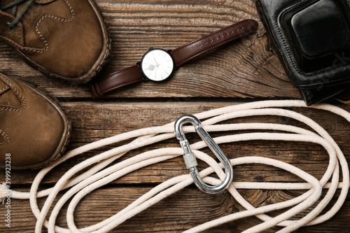 Set of travel items with rope on wooden background
