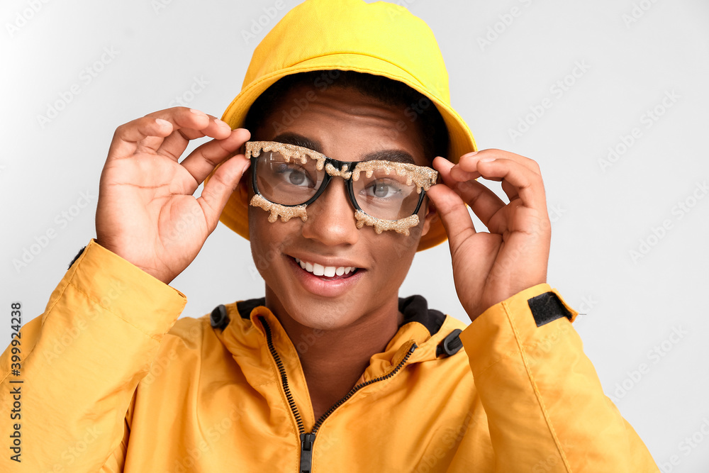 Stylish young African-American man on light background Stylish young African-American man on light background