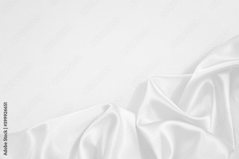 White silk satin fabric background. Copy space for text or product. Wavy soft folds. Beautiful elegant white background. White silk satin fabric background. Copy space for text or product. Wavy soft folds. Beautiful elegant white background.